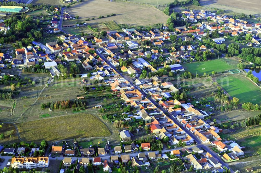 Tucheim from the bird's eye view: Agricultural land and field borders surround the settlement area of the village in Tucheim in the state Saxony-Anhalt, Germany