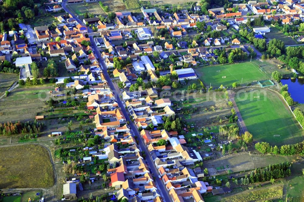 Aerial image Tucheim - Agricultural land and field borders surround the settlement area of the village in Tucheim in the state Saxony-Anhalt, Germany