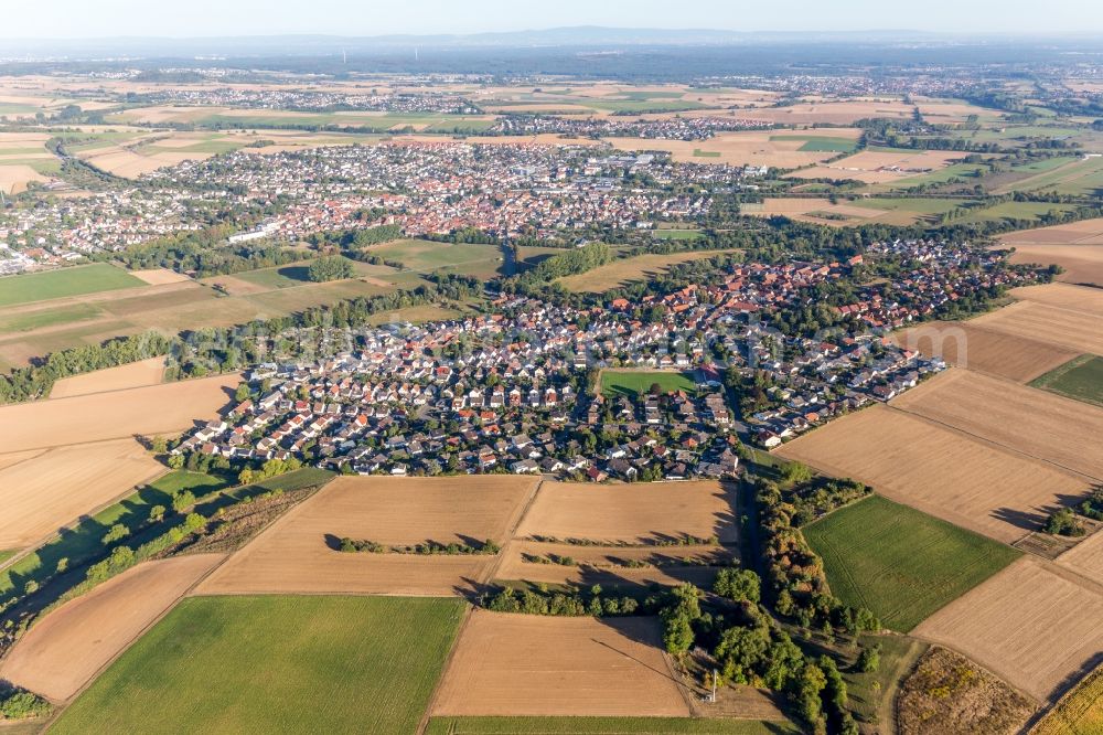 Ueberau from the bird's eye view: Agricultural land and field borders surround the settlement area of the village in Ueberau in the state Hesse, Germany