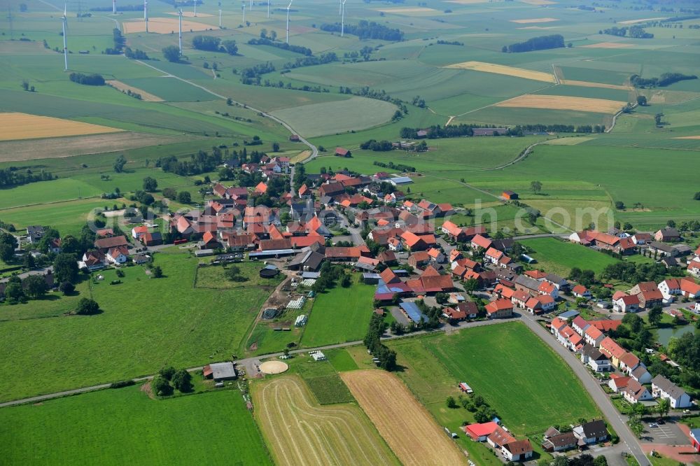 Aerial image Vasbeck - Agricultural land and field borders surround the settlement area of the village in Vasbeck in the state Hesse, Germany