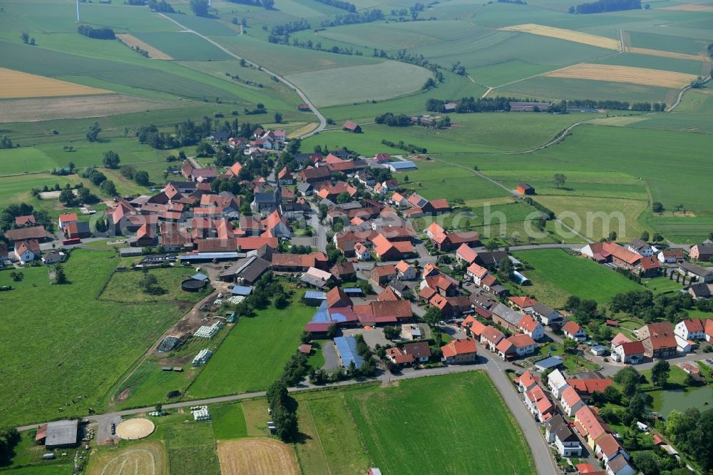 Aerial photograph Vasbeck - Agricultural land and field borders surround the settlement area of the village in Vasbeck in the state Hesse, Germany