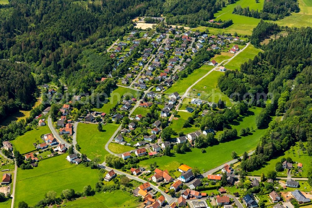 Vöhl from above - Agricultural land and field borders surround the settlement area of the village in Voehl in the state Hesse, Germany