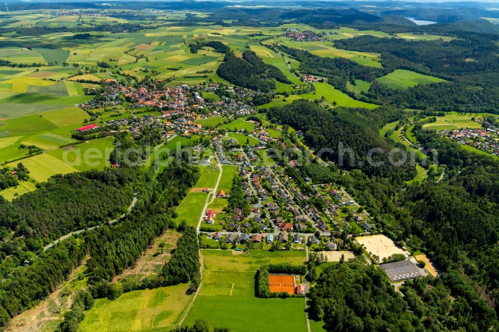 Aerial image Vöhl - Agricultural land and field borders surround the settlement area of the village in Voehl in the state Hesse, Germany