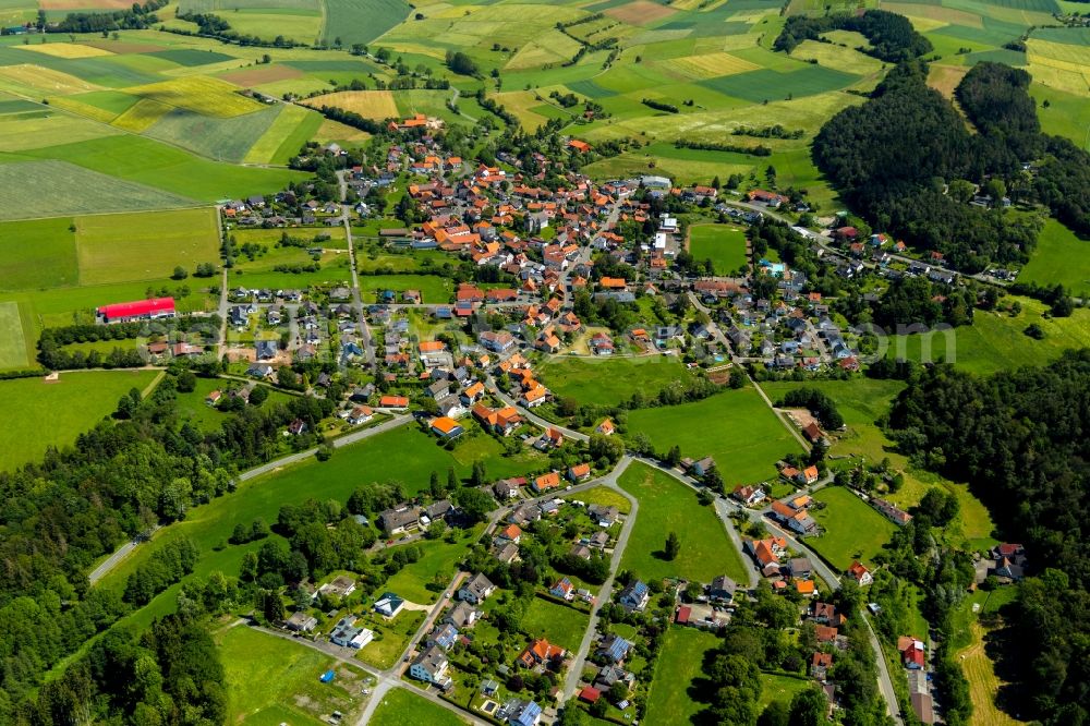 Vöhl from above - Agricultural land and field borders surround the settlement area of the village in Voehl in the state Hesse, Germany