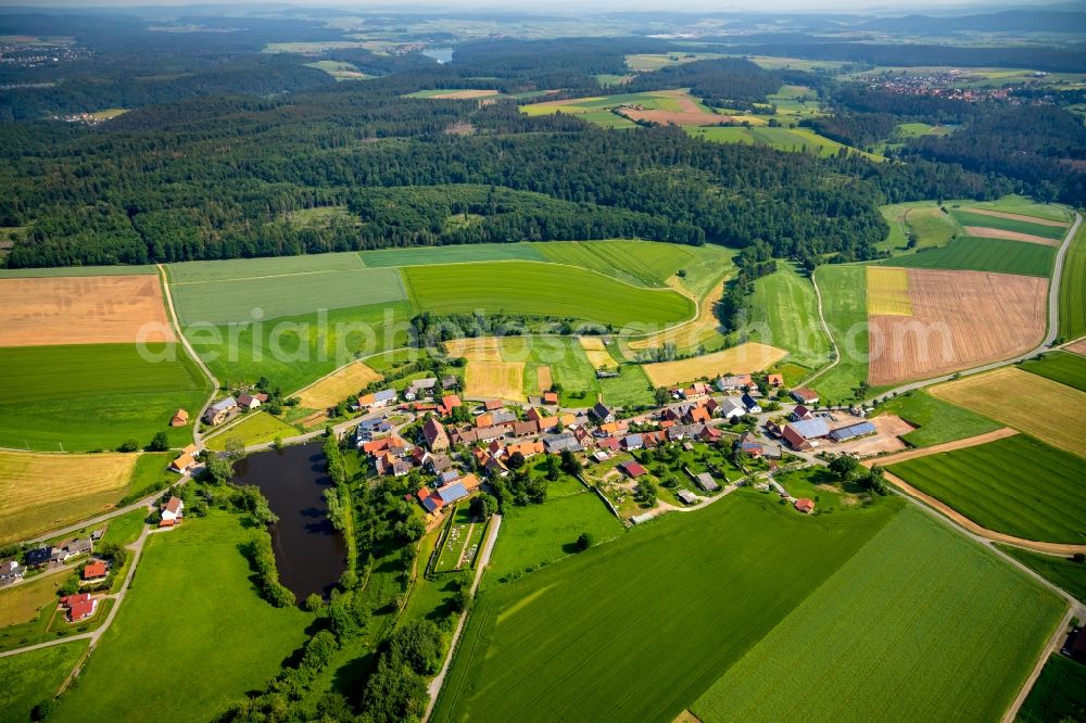 Volkhardinghausen from above - Agricultural land and field borders surround the settlement area of the village in Volkhardinghausen in the state Hesse, Germany