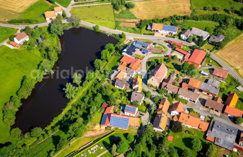 Aerial photograph Volkhardinghausen - Agricultural land and field borders surround the settlement area of the village in Volkhardinghausen in the state Hesse, Germany