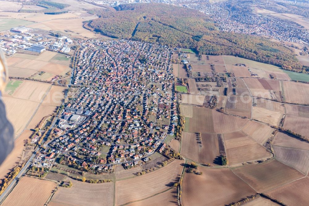 Aerial image Waldbüttelbrunn - Agricultural land and field borders surround the settlement area of the village in Waldbuettelbrunn in the state Bavaria, Germany