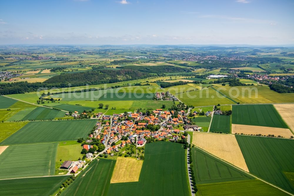 Aerial image Wethen - Agricultural land and field borders surround the settlement area of the village in Wethen in the state Hesse, Germany