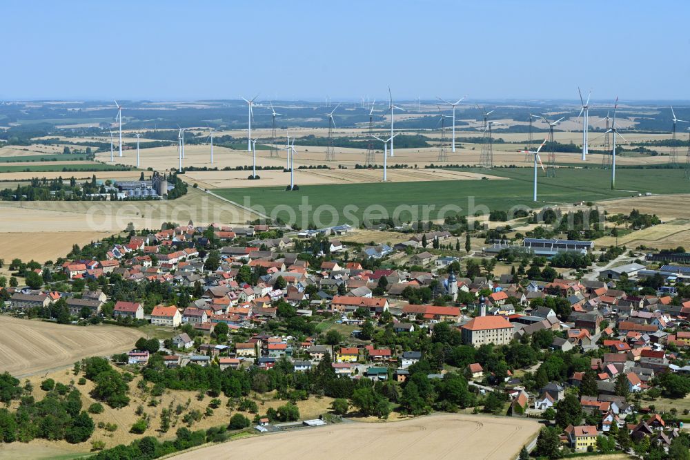 Aerial image Frauenprießnitz - Agricultural areas and field boundaries with wind turbines surround the settlement area of the village in Frauenpriessnitz in the state Thuringia, Germany