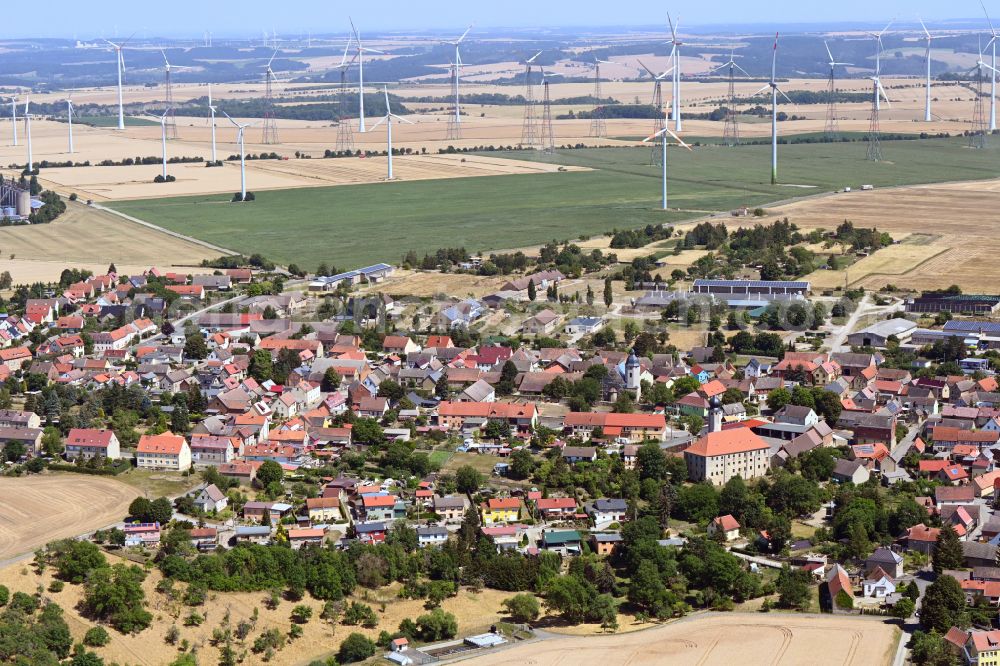 Frauenprießnitz from above - Agricultural areas and field boundaries with wind turbines surround the settlement area of the village in Frauenpriessnitz in the state Thuringia, Germany