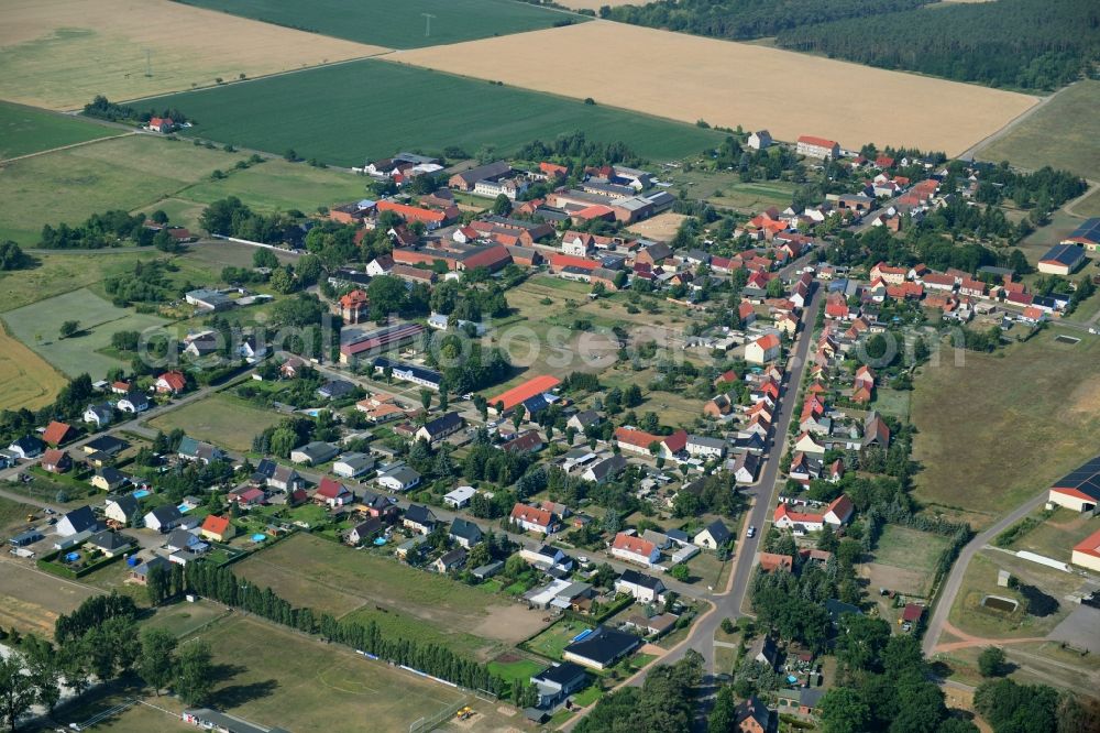 Aerial image Wörmlitz - Agricultural land and field borders surround the settlement area of the village in Woermlitz in the state Saxony-Anhalt, Germany