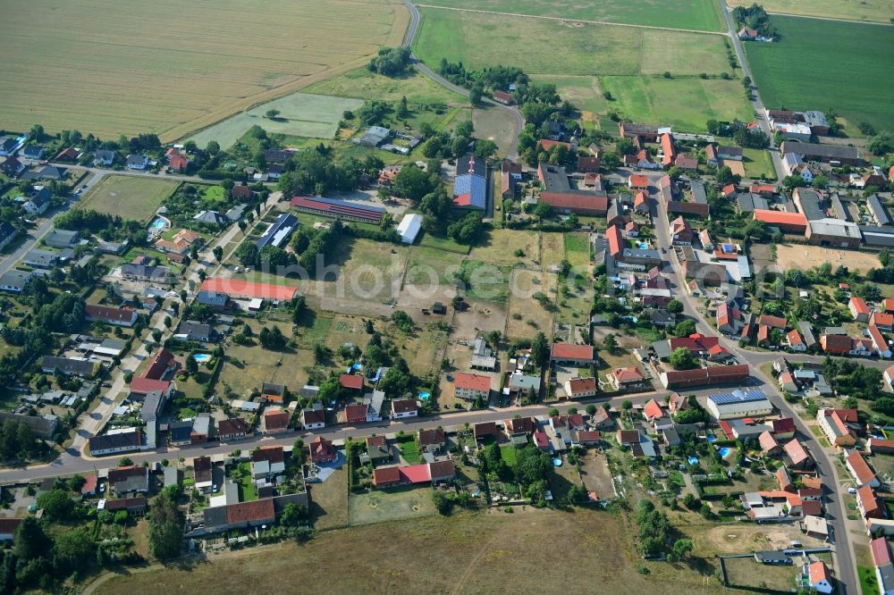 Wörmlitz from above - Agricultural land and field borders surround the settlement area of the village in Woermlitz in the state Saxony-Anhalt, Germany