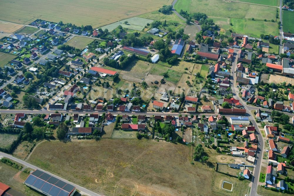 Aerial image Wörmlitz - Agricultural land and field borders surround the settlement area of the village in Woermlitz in the state Saxony-Anhalt, Germany