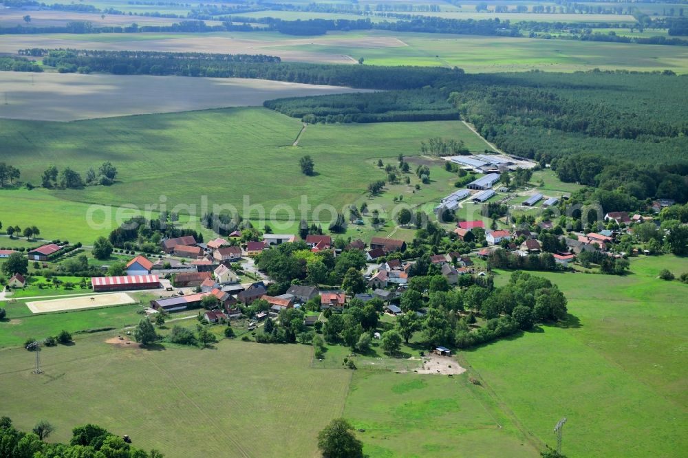 Wutzetz from above - Agricultural land and field borders surround the settlement area of the village in Wutzetz in the state Brandenburg, Germany