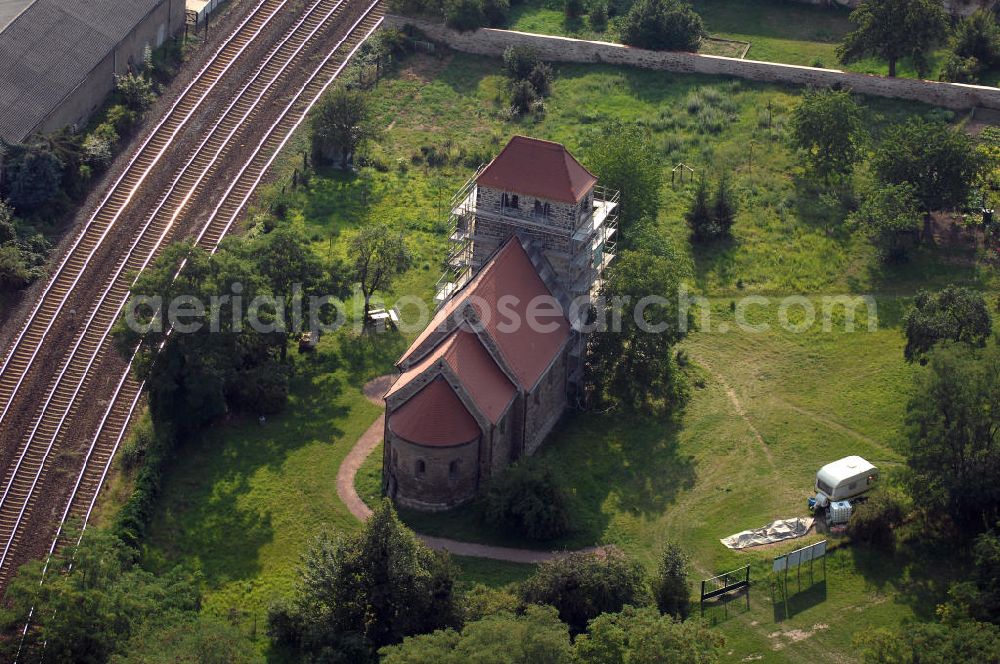 Bernburg from above - Strasse der Romanik: Blick auf die Dorfkirche St.Stephani. Gebaut etwa um 1180 steht der flach gedeckte Feldsteinbau im ehemaligen Waldau, welches seit 1871 zu Bernburg gehört. Eine umfassende Restaurierung fand 1930 statt, im Andenken an den heiligen Stephanus wurde sichtbar ein Stein aus Jerusalem in der Kirche angebracht.