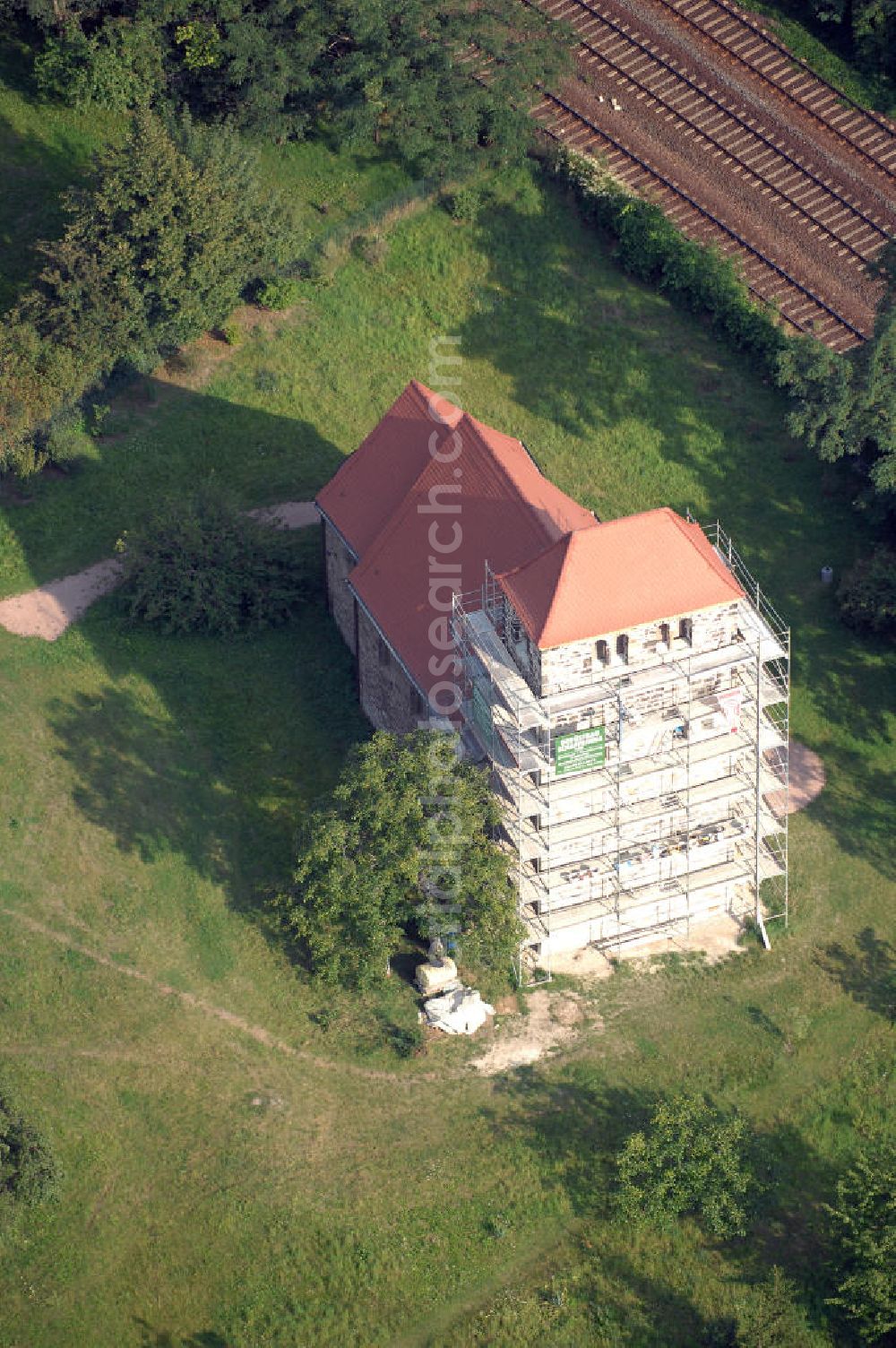 Bernburg from above - Strasse der Romanik: Blick auf die Dorfkirche St.Stephani. Gebaut etwa um 1180 steht der flach gedeckte Feldsteinbau im ehemaligen Waldau, welches seit 1871 zu Bernburg gehört. Eine umfassende Restaurierung fand 1930 statt, im Andenken an den heiligen Stephanus wurde sichtbar ein Stein aus Jerusalem in der Kirche angebracht.