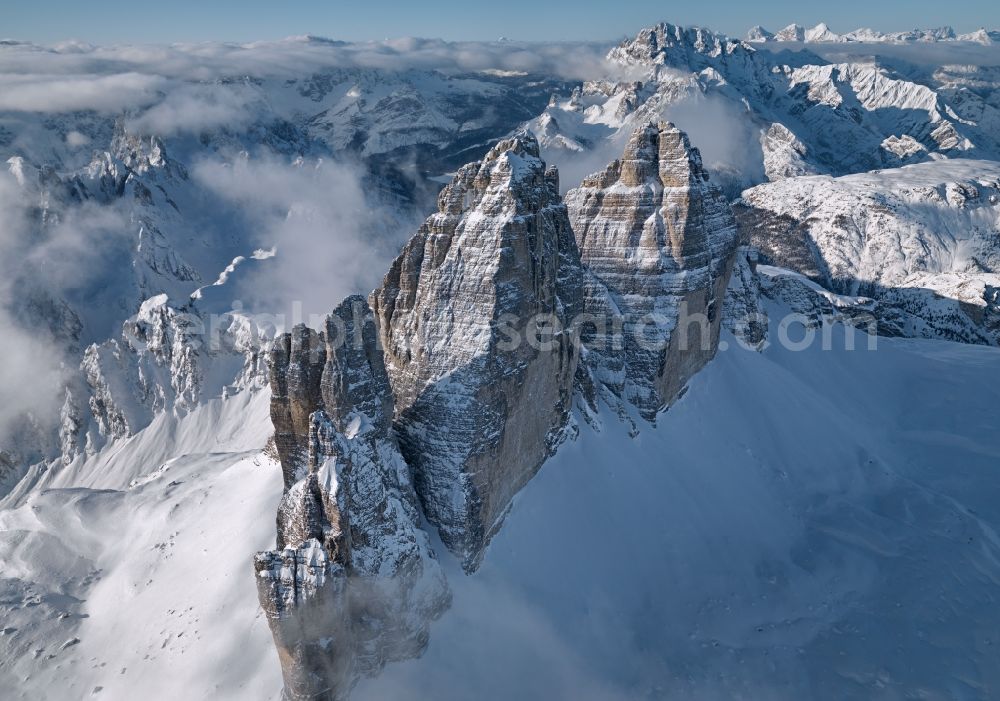 Cortina d'Ampezzo from the bird's eye view: The Three Peaks of Lavaredo, Alps, Italy These three peaks near Cortina d'Ampezzo belong to the most famous mountains in the Alps. The Three Peaks of Lavaredo - Tre Cime (in Italian) and Drei Zinnen (in German language) - are located in the Dolomites in South Tyrol. They are composed of well-layered dolostones, so called Hauptdolomit, as many other groups in the Dolomites