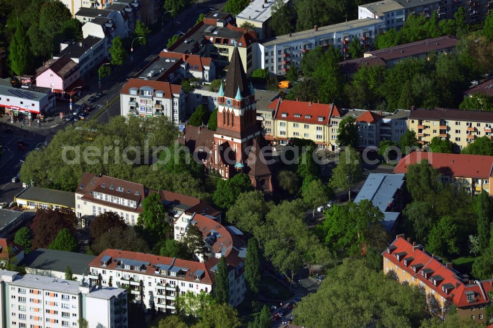 Berlin from above - The Evangelical Holy Trinity Church stands at the crossroads Kaiser-Wilhelm-Strasse - Paul-Schneider-Strasse in the district Lankwitz of Berlin. The church with its distinctive tower was built in the style of brick gothic over 100 years ago. At the inauguration of the Prince of Prussia was present. Architect of the church was Ludwig von Tiedemann