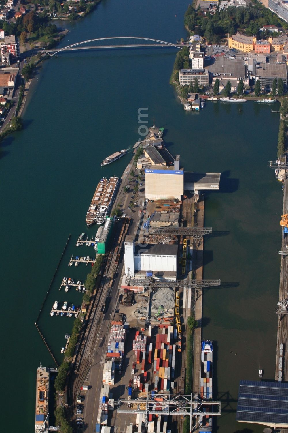 Basel from the bird's eye view: In the middle of the river Rhine the three countries Germany, Switzerland and France merge in Basel in Switzerland. A Pylon is symbolising the location in the harbor area of Basle in Switzerland