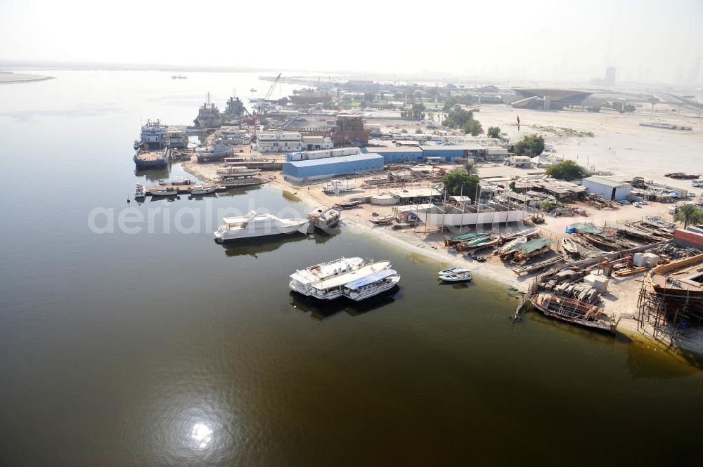 Aerial photograph Dubai - Überblick auf die Werften Drydocks World in Dubai mit der Werft der Firma GMMOS im hinteren Teil des Bildes und der Werft der traditionellen Holzschiffbaufirma Saif Mohd. Al Qaizi im Vordergrund. GMMOS beschafft u.a. Arbeitsgeräte für die Öl- und Gasindustry im Mittleren Osten und der Golfregion. Die Drydocks sind das größten Trockedocks im Persichen Golf. Overview of the Drydocks World in Dubai. They consist mainly of the dockyards of GMMOS (in the background) and the manufecterers of wooden ships Saif Mohd. Al Qaiz (in the foreground. GMMOS provides equipment to the oil and gas industry in the Middel East and Gulf region. The Drydocks are the only large drydocks facility in the Persian Gulf.