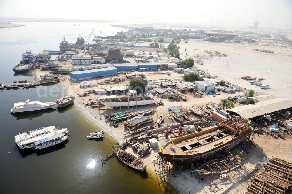 Dubai from above - Überblick auf die Werften Drydocks World in Dubai mit der Werft der Firma GMMOS im hinteren Teil des Bildes und der Werft der traditionellen Holzschiffbaufirma Saif Mohd. Al Qaizi im Vordergrund. GMMOS beschafft u.a. Arbeitsgeräte für die Öl- und Gasindustry im Mittleren Osten und der Golfregion. Die Drydocks sind das größten Trockedocks im Persichen Golf. Overview of the Drydocks World in Dubai. They consist mainly of the dockyards of GMMOS (in the background) and the manufecterers of wooden ships Saif Mohd. Al Qaiz (in the foreground. GMMOS provides equipment to the oil and gas industry in the Middel East and Gulf region. The Drydocks are the only large drydocks facility in the Persian Gulf.