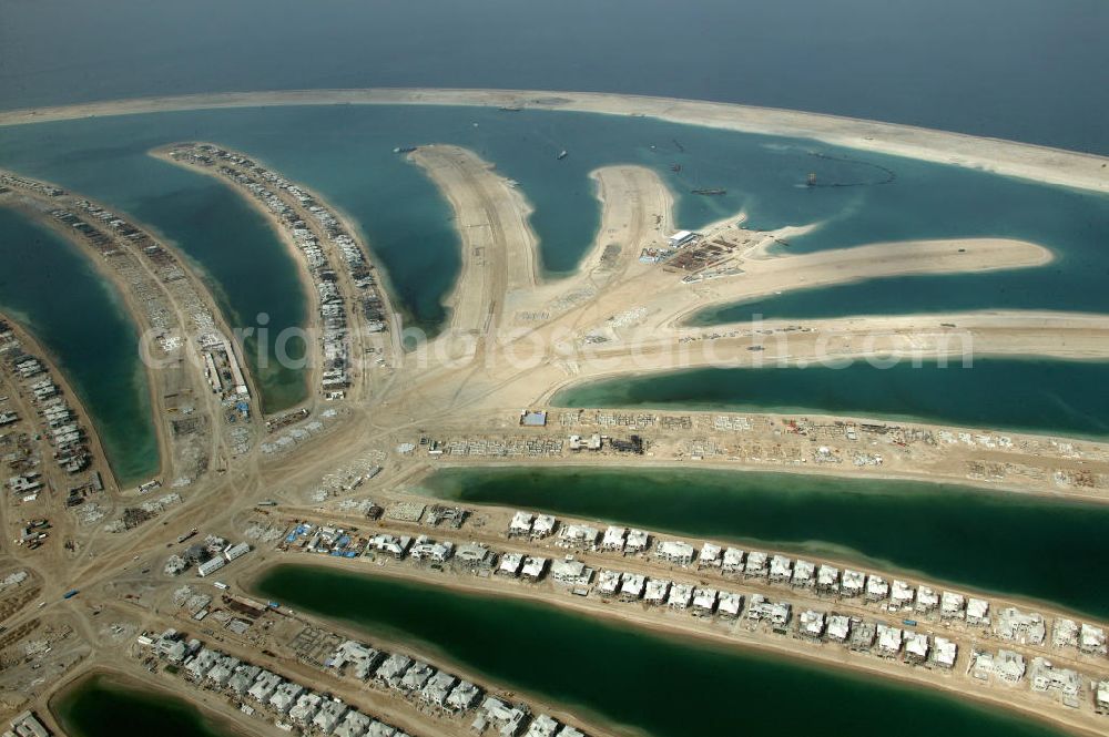 Aerial image Dubai - Die künstliche Insel Palm Jumeirah. Die beiden Inseln The Palm, Jumeirah und The Palm, Jebel Ali, zusammen Palm Islands, sind zwei künstliche Inseln, die vor Dubai im Persischen Golf angelegt wurden. Die Inseln bestehen aus rund 100 Millionen Kubikmeter Fels und durch ein spezielles Rüttelverfahren verdichtetem Sand und sind in Form einer Palme angelegt. Allein die 560 Hektar große Insel The Palm, Jumeirah wird die Küstenlinie Dubais um ca. 100 km verlängern. Bauherr ist die staatseigene Entwicklungs- und Baugesellschaft Nakheel. Die Erdbauarbeiten führen die niederländischen Firmen Royal Boskalis Westminster und Van Oord aus. Die Arbeiten an der Insel Palm Jumeirah wurden 2001 begonnen, im Dezember 2006 waren die ersten Apartements bezugsfertig. Neben Apartementhäusern gibt es auf der Insel Vergnügungsparks, Luxushotels, Einkaufszentren, etc. Die Palm Islands sollen durch eine dritte Insel, Palm Deira, ergänzt werden, die die beiden bestehenden Inseln vom Ausmaß her weit übertreffen wird. / AE, United Arab Emirates, Dubai: Palm Jumeirah. Palm Jumeirah and Palm Jebel Ali are two artificial island with hotels, real estates, shops and large beaches for tourism. Kontakt Nakheel: P.O. Box 17777, Dubai, United Arab Ermirates, Tel. +971 4390333 Fax +971 43903314, Email: info@nakheel.com; Kontakt Royal Boskalis Westminster: Tel. +31(0)79 6969000 Fax +31(0)78 6969555, Email: info@hoskalis.nl; Kontakt Van Oord: Tel. +31(0)10 4478444, Fax +31(0)10 4478100, Email: info@vanoord.com.