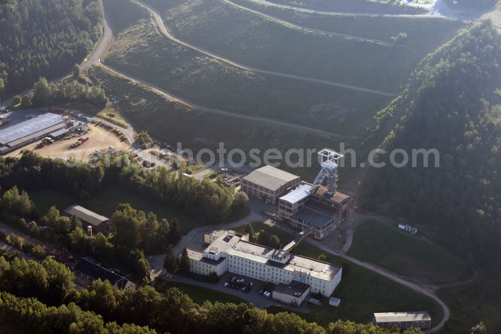 Hartenstein from above - Former headframe and mining pit Schacht 371 of SDAG Wismut in the Poppenwald forest in the borough of Hartenstein in the state of Saxony. The pit was the main pit of the now disused mining company of Aue and is used as a museum of the mineral collection of Wismut GmbH