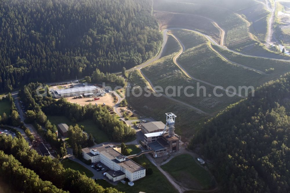 Aerial image Hartenstein - Former headframe and mining pit Schacht 371 of SDAG Wismut in the Poppenwald forest in the borough of Hartenstein in the state of Saxony. The pit was the main pit of the now disused mining company of Aue and is used as a museum of the mineral collection of Wismut GmbH