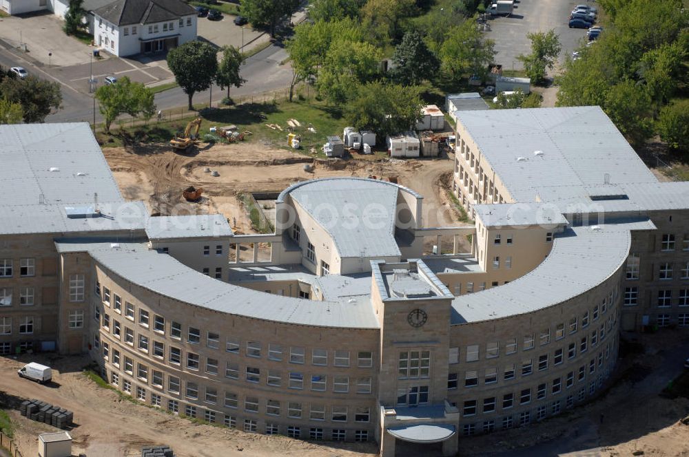 Aerial photograph Bitterfeld-Wolfen - Blick auf die ehemalige Filmfabrik Wolfen (ORWO). Das Gebäude 041 wird derzeit für die Nutzung als Verwaltungszentrum Bitterfeld-Wolfen umgebaut. Das denkmalgeschützte Gebäude wird nach zehnjährigem Leerstand durch ortsansässige Firmen saniert. Bauherr ist die Wohnungs- und Baugesellschaft Wolfen mbH (WBG). Kontakt WBG: Tel. +49(0)3494 3661100, Email: info@wbgwolfen.de