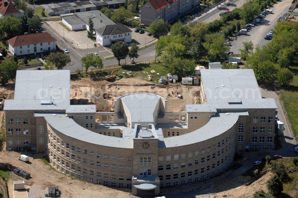 Bitterfeld-Wolfen from above - Blick auf die ehemalige Filmfabrik Wolfen (ORWO). Das Gebäude 041 wird derzeit für die Nutzung als Verwaltungszentrum Bitterfeld-Wolfen umgebaut. Das denkmalgeschützte Gebäude wird nach zehnjährigem Leerstand durch ortsansässige Firmen saniert. Bauherr ist die Wohnungs- und Baugesellschaft Wolfen mbH (WBG). Kontakt WBG: Tel. +49(0)3494 3661100, Email: info@wbgwolfen.de