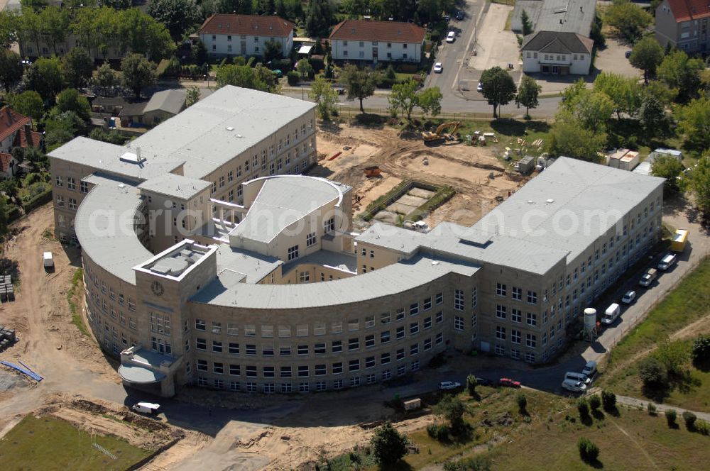 Aerial photograph Bitterfeld-Wolfen - Blick auf die ehemalige Filmfabrik Wolfen (ORWO). Das Gebäude 041 wird derzeit für die Nutzung als Verwaltungszentrum Bitterfeld-Wolfen umgebaut. Das denkmalgeschützte Gebäude wird nach zehnjährigem Leerstand durch ortsansässige Firmen saniert. Bauherr ist die Wohnungs- und Baugesellschaft Wolfen mbH (WBG). Kontakt WBG: Tel. +49(0)3494 3661100, Email: info@wbgwolfen.de