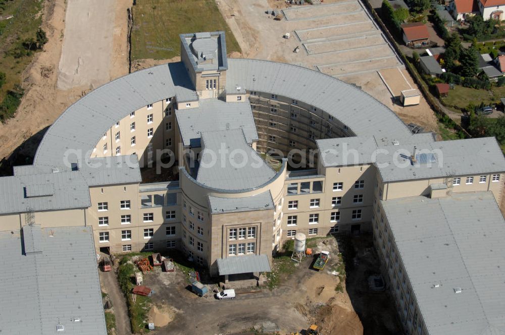 Aerial photograph Bitterfeld-Wolfen - Blick auf die ehemalige Filmfabrik Wolfen (ORWO). Das Gebäude 041 wird derzeit für die Nutzung als Verwaltungszentrum Bitterfeld-Wolfen umgebaut. Das denkmalgeschützte Gebäude wird nach zehnjährigem Leerstand durch ortsansässige Firmen saniert. Bauherr ist die Wohnungs- und Baugesellschaft Wolfen mbH (WBG). Kontakt WBG: Tel. +49(0)3494 3661100, Email: info@wbgwolfen.de