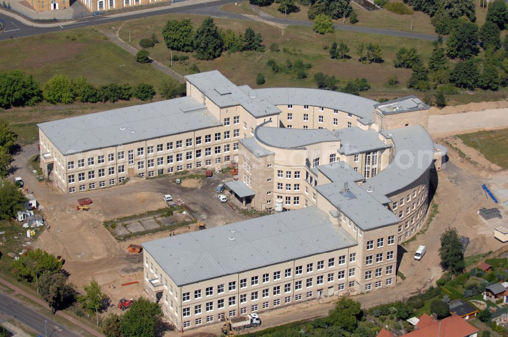 Aerial image Bitterfeld-Wolfen - Blick auf die ehemalige Filmfabrik Wolfen (ORWO). Das Gebäude 041 wird derzeit für die Nutzung als Verwaltungszentrum Bitterfeld-Wolfen umgebaut. Das denkmalgeschützte Gebäude wird nach zehnjährigem Leerstand durch ortsansässige Firmen saniert. Bauherr ist die Wohnungs- und Baugesellschaft Wolfen mbH (WBG). Kontakt WBG: Tel. +49(0)3494 3661100, Email: info@wbgwolfen.de