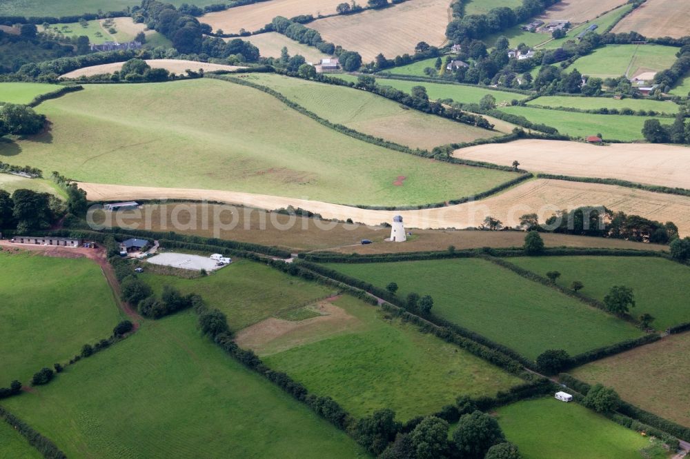 North Whilborough from above - Historic windmill on a farm homestead on the edge of cultivated fields in North Whilborough in England, United Kingdom