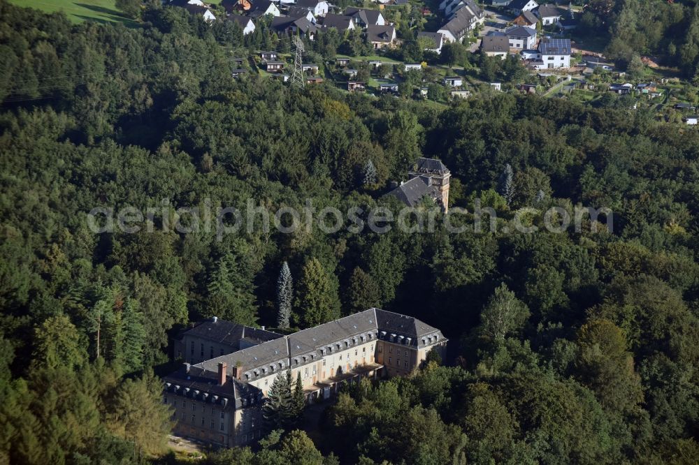 Aerial photograph Bad Schlema - Former sanatorium in a forest in Bad Schlema in the state of Saxony. The sanatorium was opened in the 1950s by SDAG Wismut and is empty today