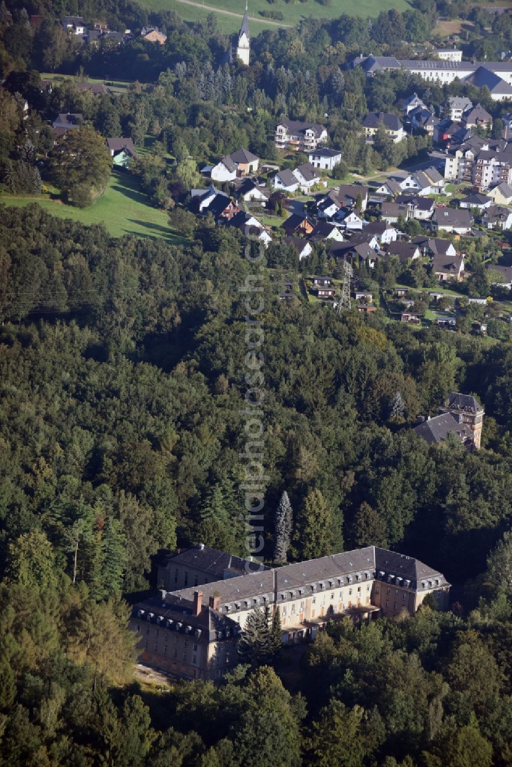 Bad Schlema from the bird's eye view: Former sanatorium in a forest in Bad Schlema in the state of Saxony. The sanatorium was opened in the 1950s by SDAG Wismut and is empty today