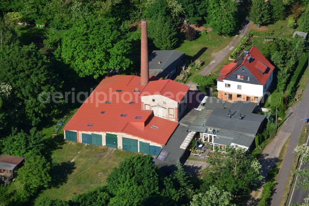 Aerial image Roßdorf - Single family house and factory in Rossdorf in the state of Saxony-Anhalt. The building complex with its chimney and factory is surrounded by forest and located on federal road B1