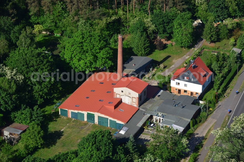 Roßdorf from above - Single family house and factory in Rossdorf in the state of Saxony-Anhalt. The building complex with its chimney and factory is surrounded by forest and located on federal road B1