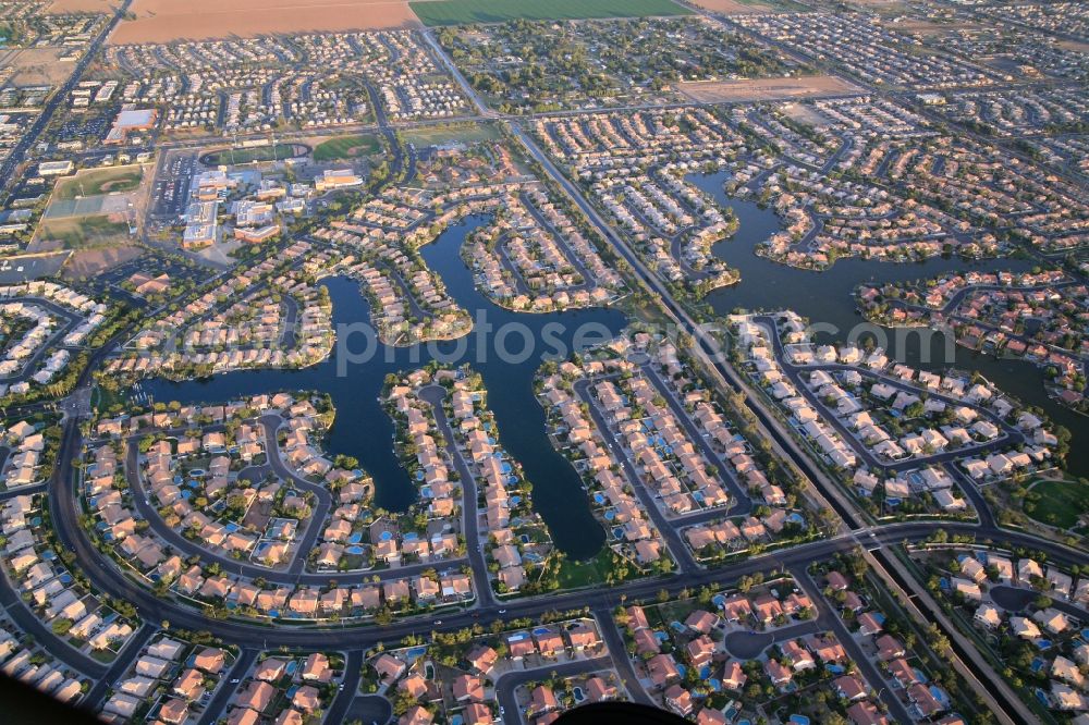 Avondale from the bird's eye view: Residential development in the greater Phoenix area in Avondale, Arizona in USA. Dense development, close neighborhood, but also generous development with lakes and countryside. An oasis in the desert