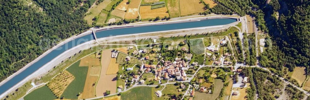 Aerial image Rochebrune - Fields and entrance to the underground canal in Rochebrune in Provence-Alpes-Cote d'Azur, France