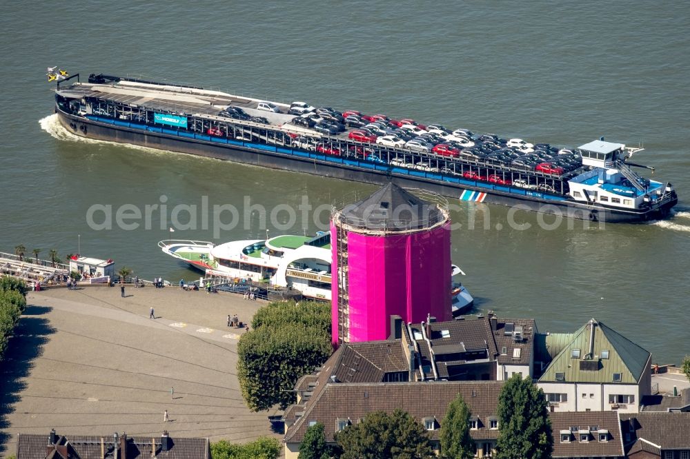 Düsseldorf from the bird's eye view: Scaffolding on the historic Schlossturm tower on the riverbank of the Rhine in Duesseldorf in the state of North Rhine-Westphalia. A freight ship loaded with cars and the panorama ship MS Warsteiner of KD is located in the background