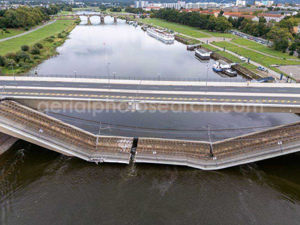 Dresden from above - Concrete segments of the collapsed river bridge structure for crossing the Elbe Carolabruecke on the street Carolabruecke in Dresden in the federal state of Saxony, Germany, have fallen down into the riverbed of the Elbe