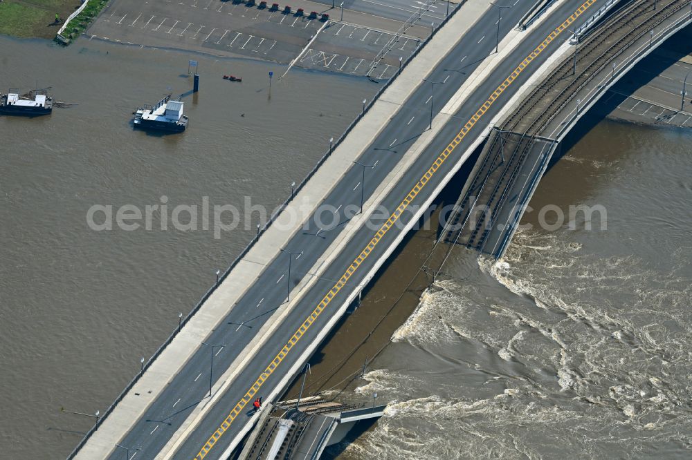 Dresden from above - Concrete segments of the collapsed river bridge structure for crossing the Elbe Carolabruecke on the street Carolabruecke in Dresden in the federal state of Saxony, Germany, have fallen down into the riverbed of the Elbe