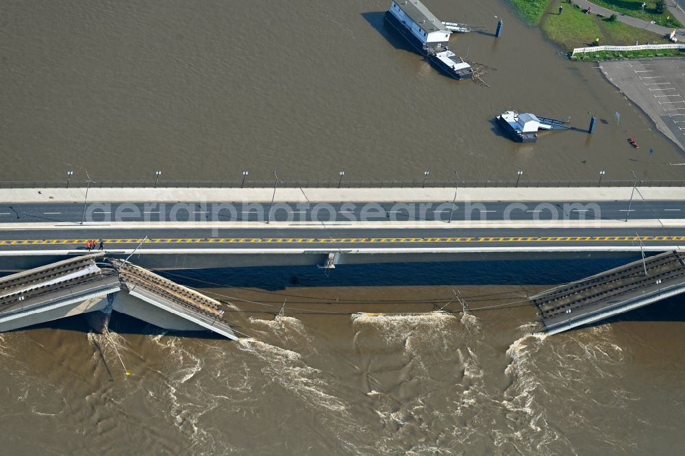 Aerial image Dresden - Concrete segments of the collapsed river bridge structure for crossing the Elbe Carolabruecke on the street Carolabruecke in Dresden in the federal state of Saxony, Germany, have fallen down into the riverbed of the Elbe