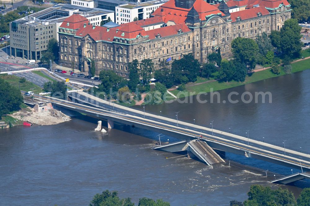 Dresden from above - Concrete segments of the collapsed river bridge structure for crossing the Elbe Carolabruecke on the street Carolabruecke in Dresden in the federal state of Saxony, Germany, have fallen down into the riverbed of the Elbe