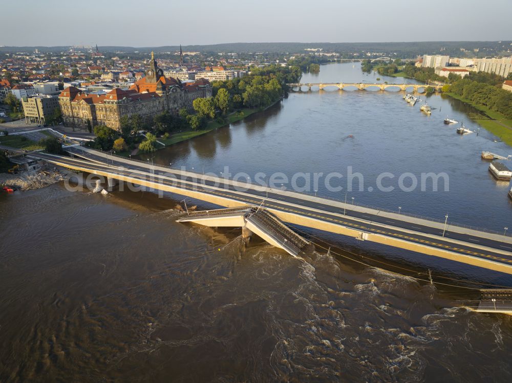 Dresden from above - Concrete segments of the collapsed river bridge structure for crossing the Elbe Carolabruecke on the street Carolabruecke in Dresden in the federal state of Saxony, Germany, have fallen down into the riverbed of the Elbe