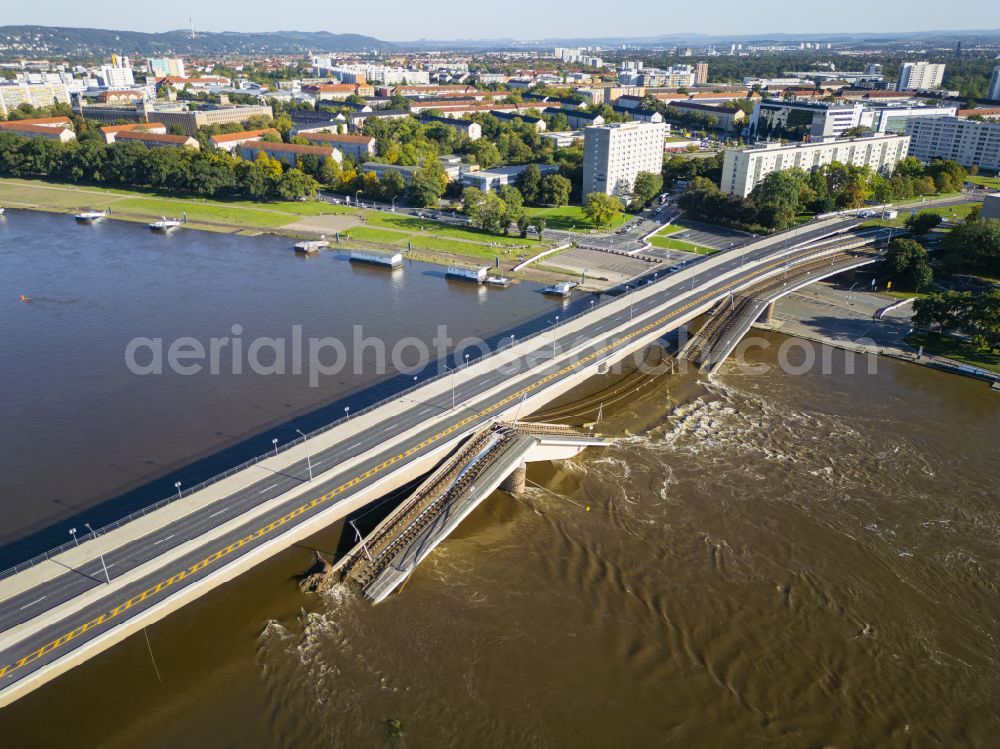 Dresden from above - Concrete segments of the collapsed river bridge structure for crossing the Elbe Carolabruecke on the street Carolabruecke in Dresden in the federal state of Saxony, Germany, have fallen down into the riverbed of the Elbe