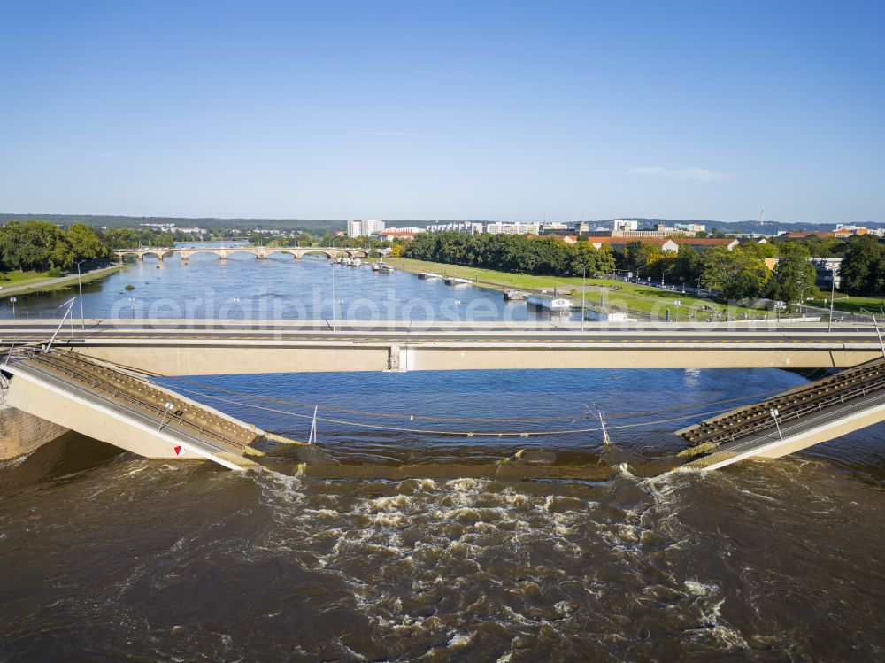 Dresden from above - Concrete segments of the collapsed river bridge structure for crossing the Elbe Carolabruecke on the street Carolabruecke in Dresden in the federal state of Saxony, Germany, have fallen down into the riverbed of the Elbe