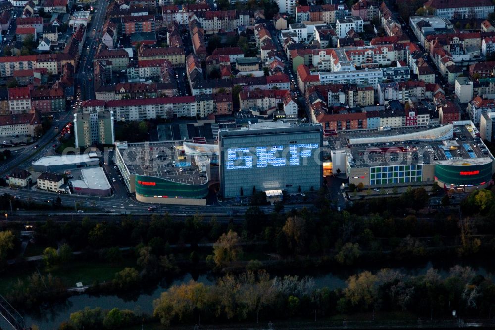 Aerial image Schweinfurt - Building of the shopping center Stadtgalerie Schweinfurt and illumated SKF Hochhaus at dawn in Schweinfurt in the state Bavaria, Germany