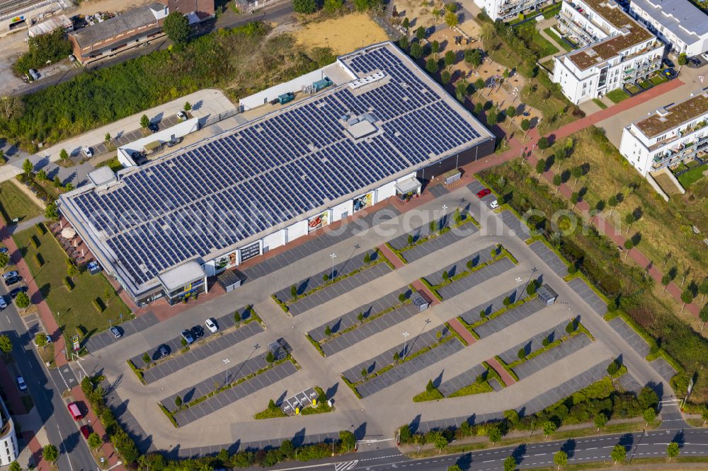 Aerial photograph Osterath - Building of the shopping center EDEKA on Gottlieb-Daimler-Strasse in Osterath in the federal state of North Rhine-Westphalia, Germany